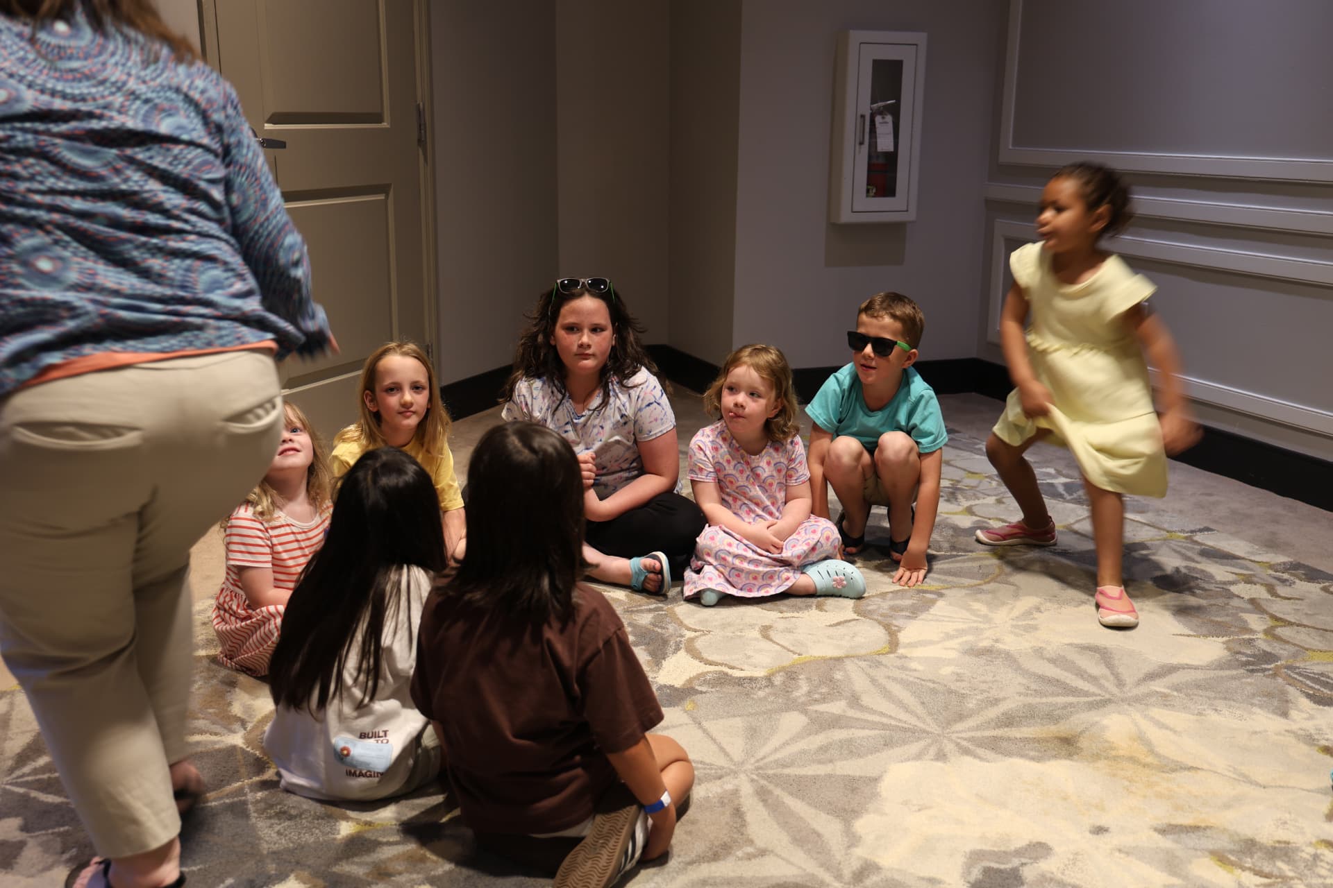 Kids gathered on the floor at a Topflight family event